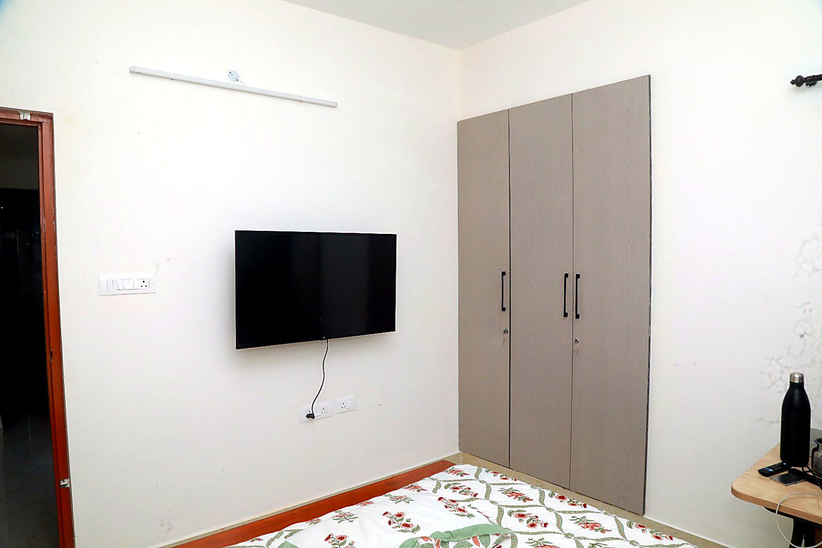 Bedroom with wall-mounted TV